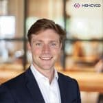 A man in a suit smiling at the camera with a blurred office background and the MEMCYCO logo in the top right corner, highlighting Memcyco at IAFCI Spotlight on Fraud 2026.